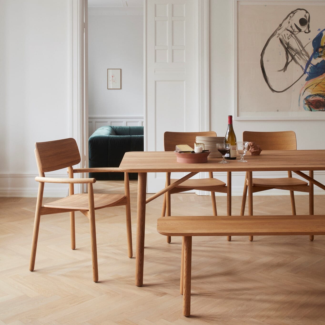 Moderne spisestue med spisebord i eik, matchende spisestoler og benk i skandinavisk design.