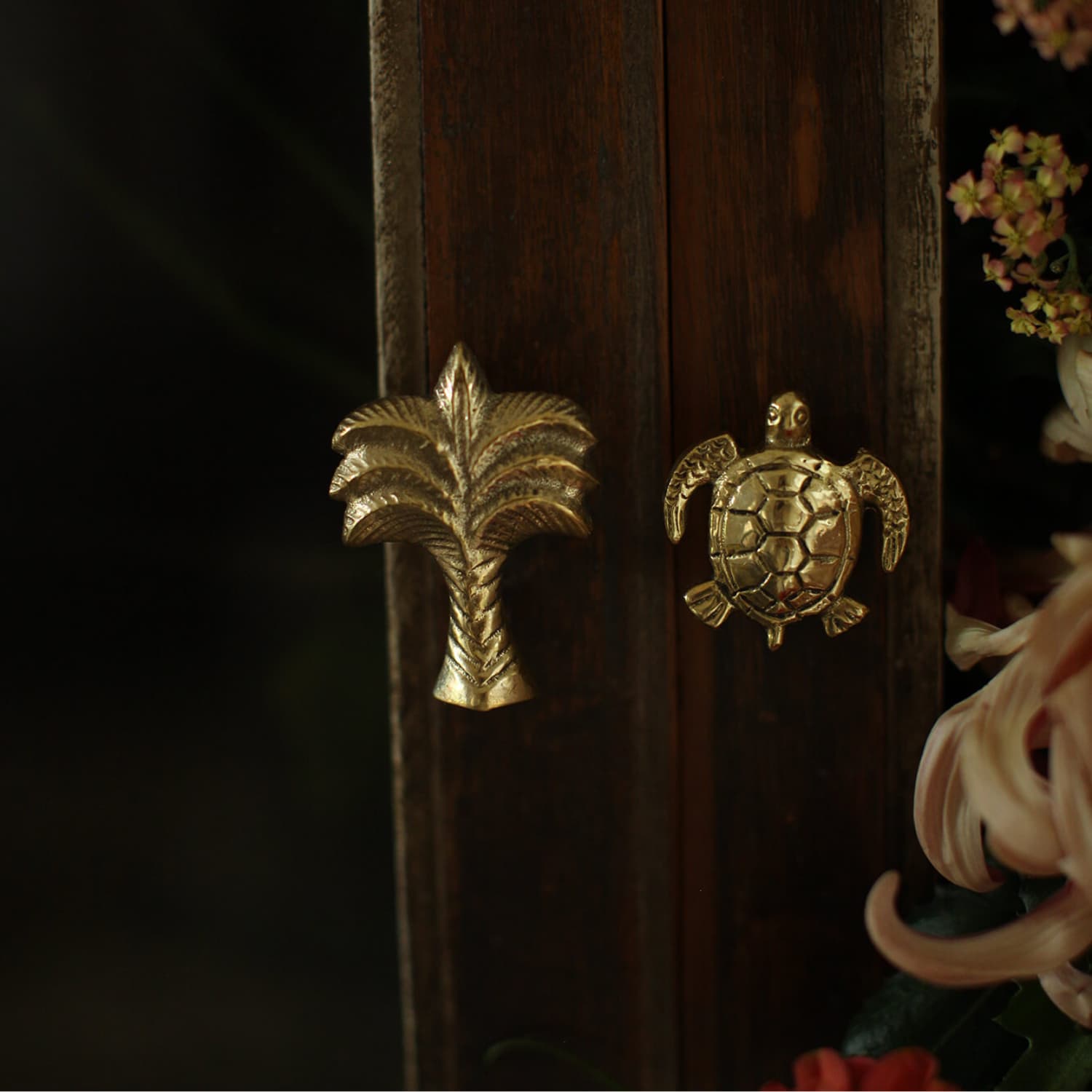 Moderne knotter i messing, med formen av en palme og skilpadde.